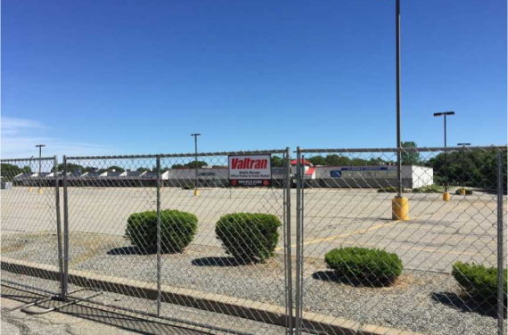 A chainlink fence with a Valtran sign on it.